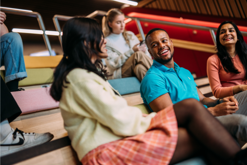 students sitting chatting on staircase